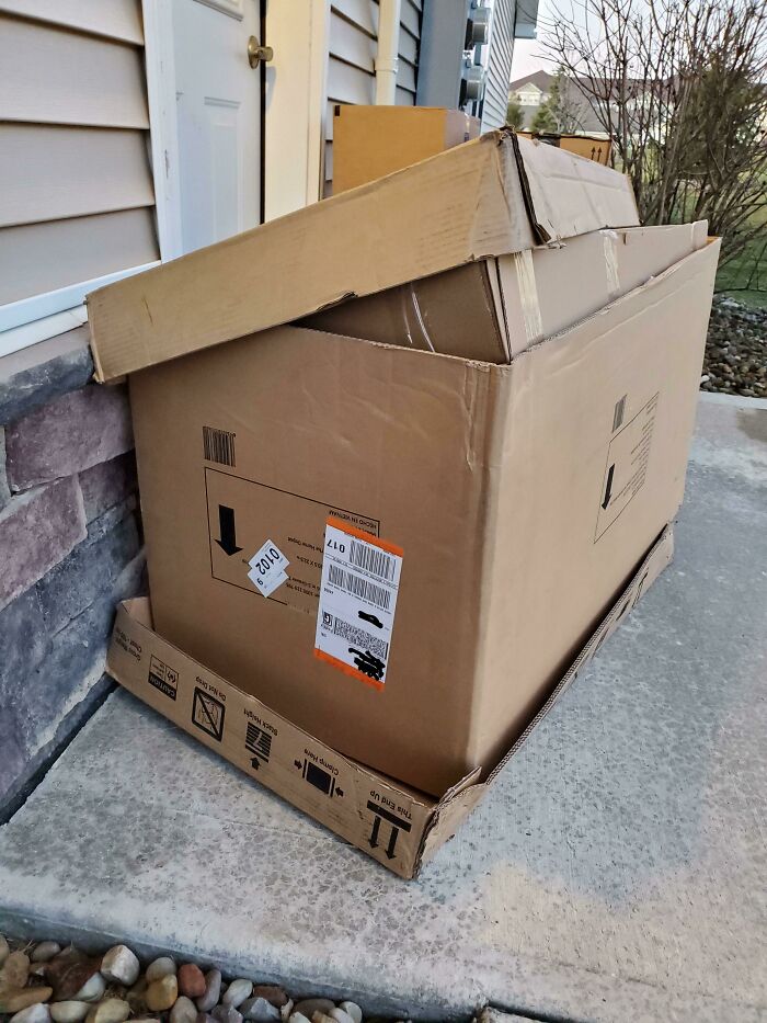 Oversized cardboard box blocking a doorway, symbolizing lazy-infuriating people.