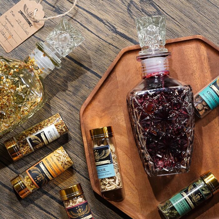 Subscription box featuring decorative glass bottles and spice jars on a wooden surface.