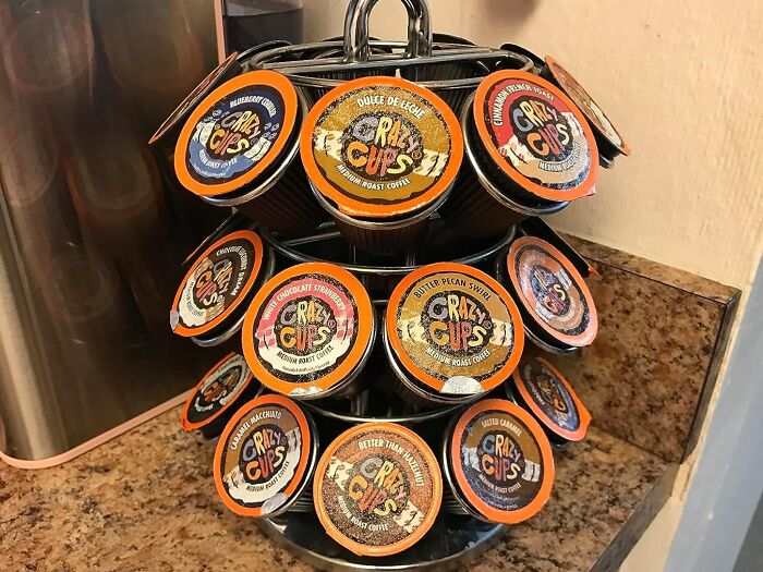 Subscription boxes display featuring various Crazy Cups coffee flavors in a rotating rack on a countertop.