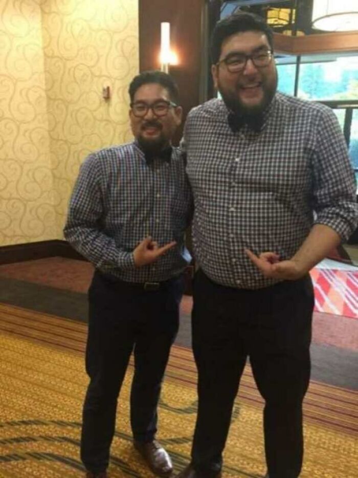 Two men in matching plaid shirts, smiling and pointing at each other, creating a fascinating picture moment.