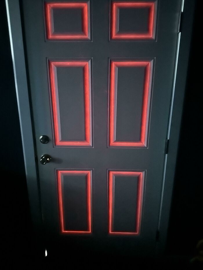 A door in dim light with red trim, creating a video game-like appearance.