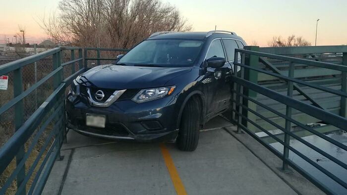 SUV stuck on a pedestrian bridge, illustrating lazy-infuriating-people parking situation.