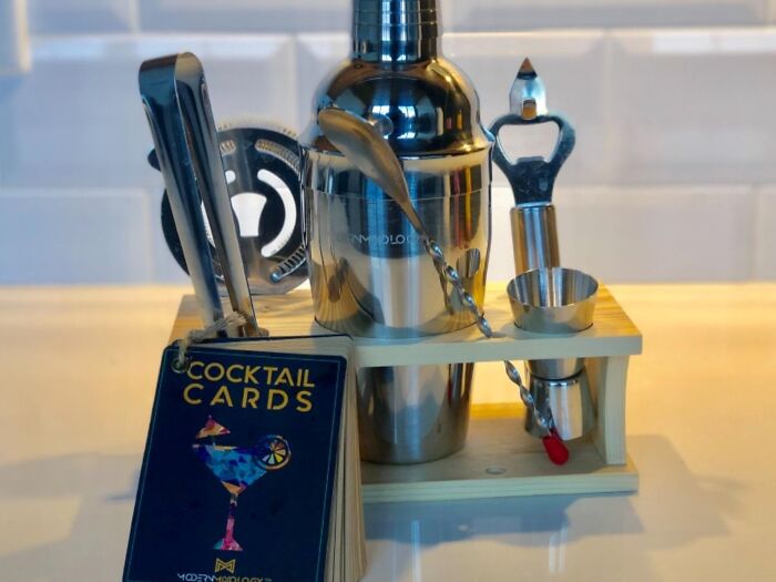 Cocktail making set featuring shaker, spoon, and tongs with cocktail cards.