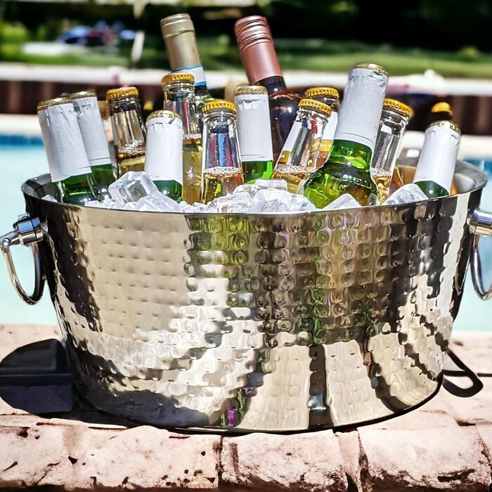 Ice bucket filled with assorted bottled drinks, perfect for party hosting tips.