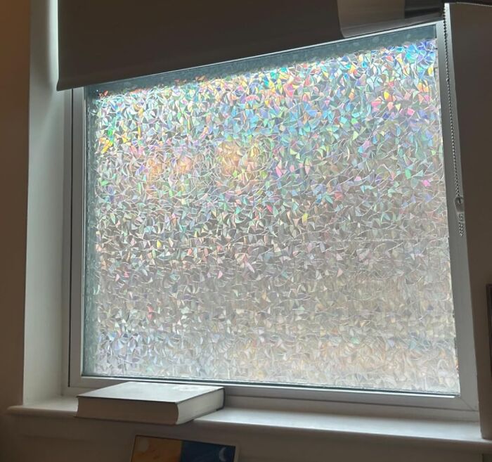 Decorative window film in room, showcasing Reddit room upgrades with prismatic patterns.