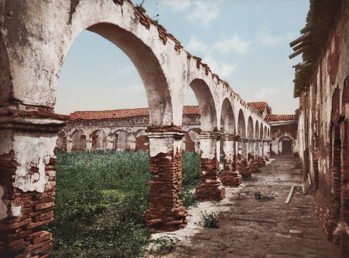 Old color photo of ancient arches revealing historical architecture and environment from 100 years ago.