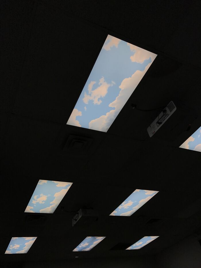 Ceiling lights resembling a sky with clouds, creating a surreal effect like in videogames.