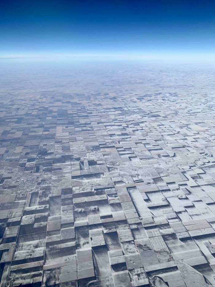 Aerial view of farmland resembling a grid, with real-life photos looking like bad renders.