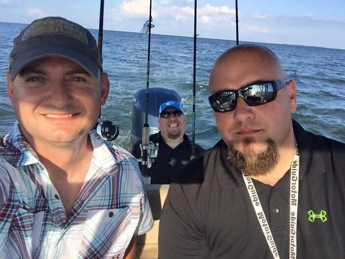 Three men fishing on a boat, looking like bad renders under a bright sky.