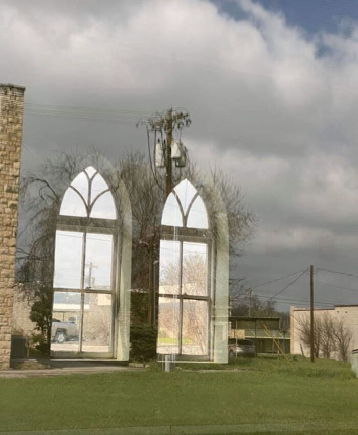 A surreal scene with architectural elements resembling a bad render against a cloudy sky backdrop.