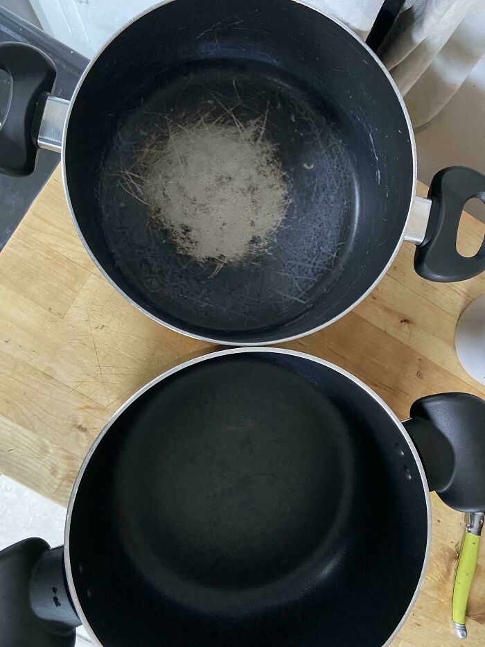 Scratched and blackened pans on a wooden countertop, illustrating horrible roommates' cookware habits.