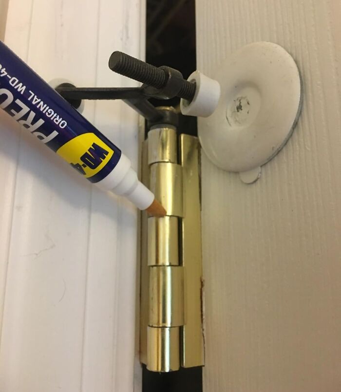 WD-40 pen applied to door hinge for maintenance, showcasing best buys from Amazon.