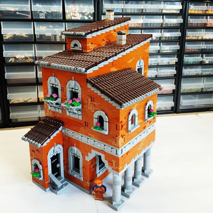 Cool LEGO builds of a detailed orange house with columns and flowers, set against a background of organized storage drawers.