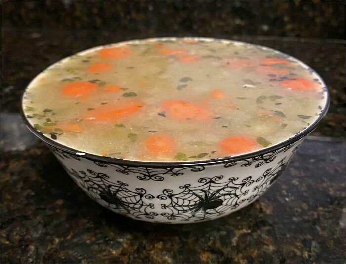 Bowl filled to the brim with soup, achieving a satisfying perfect fit.