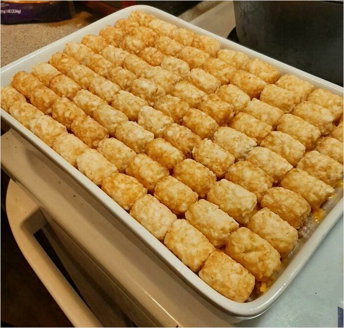 Perfectly arranged tater tots in a baking dish for a satisfying perfect fit.