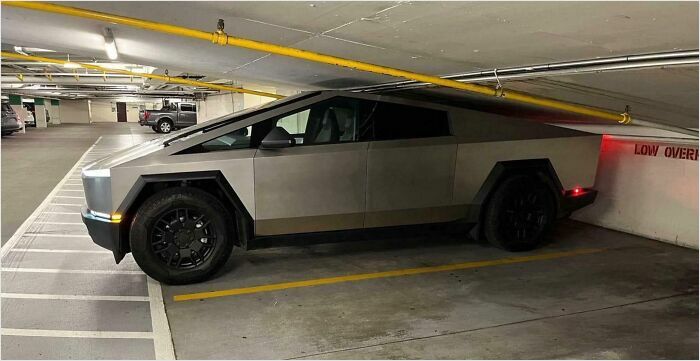 A car perfectly fitting in a low-ceiling parking spot, emphasizing a satisfying fit.