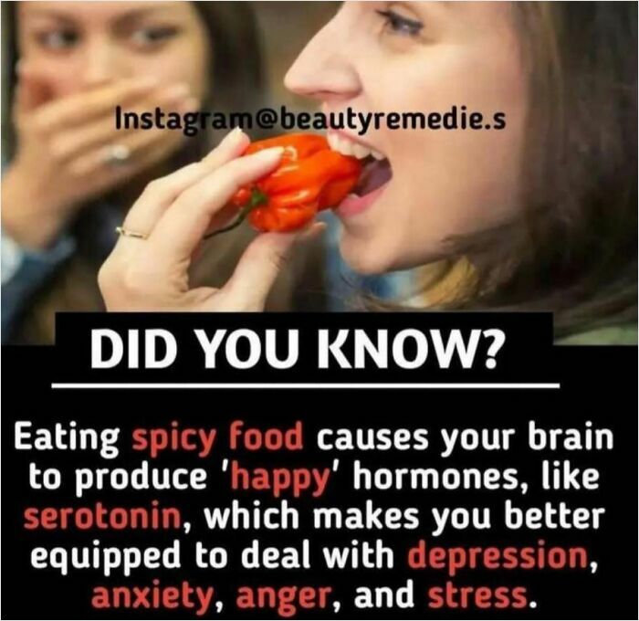 Person eating a red pepper, highlighting spicy food's role in boosting serotonin for managing stress and anxiety.