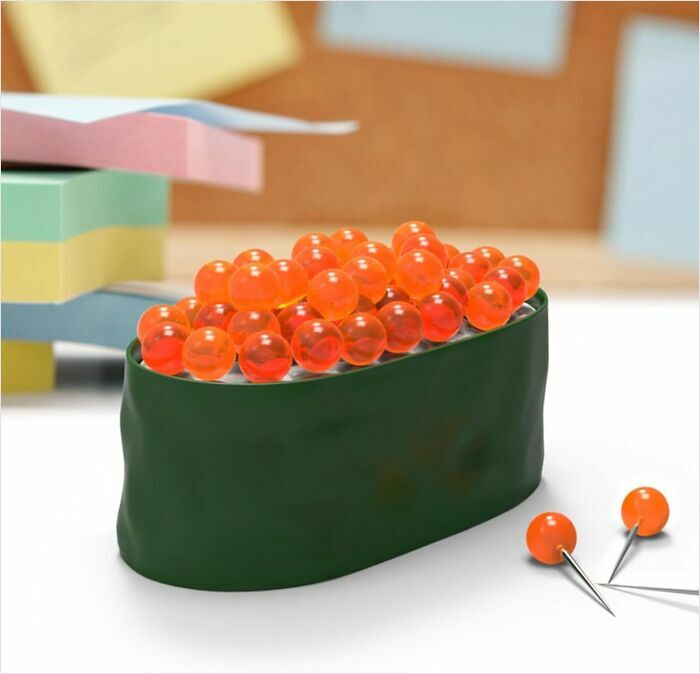 Sushi-shaped pushpins, a quirky desk accessory, beside colorful sticky notes, embodying the coolest things we covet.