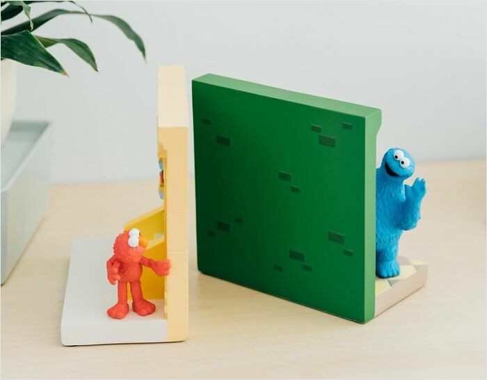 Cute figurine bookends featuring colorful characters in a whimsical, minimalist design.