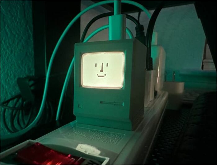 Retro-style gadget with smiley face display, illuminated in green, exemplifying coolest things tech enthusiasts covet.