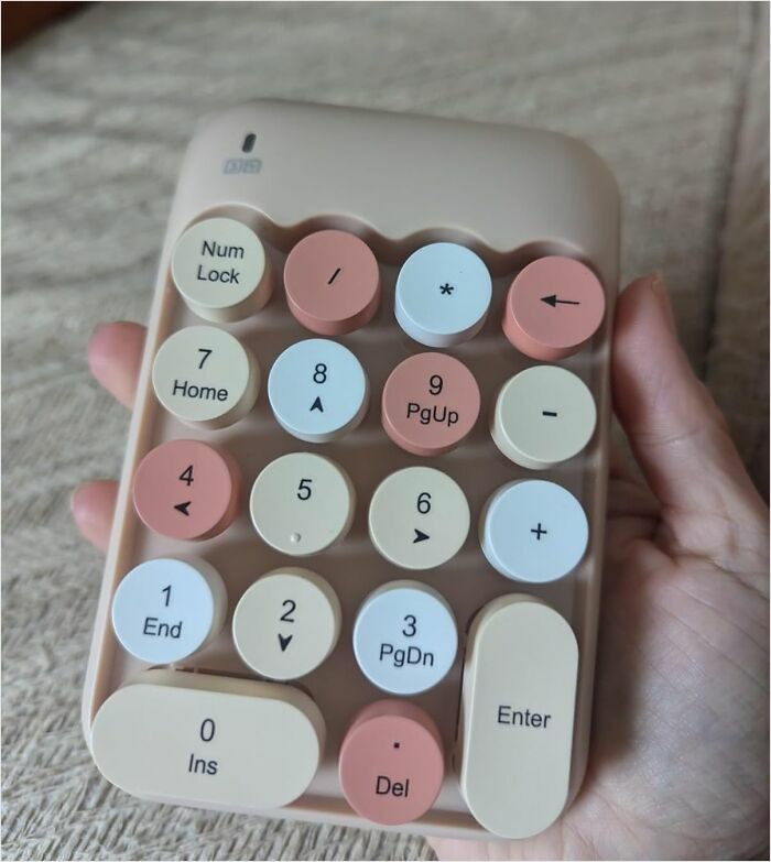 Round pastel-colored numeric keypad, a sleek design gadget.