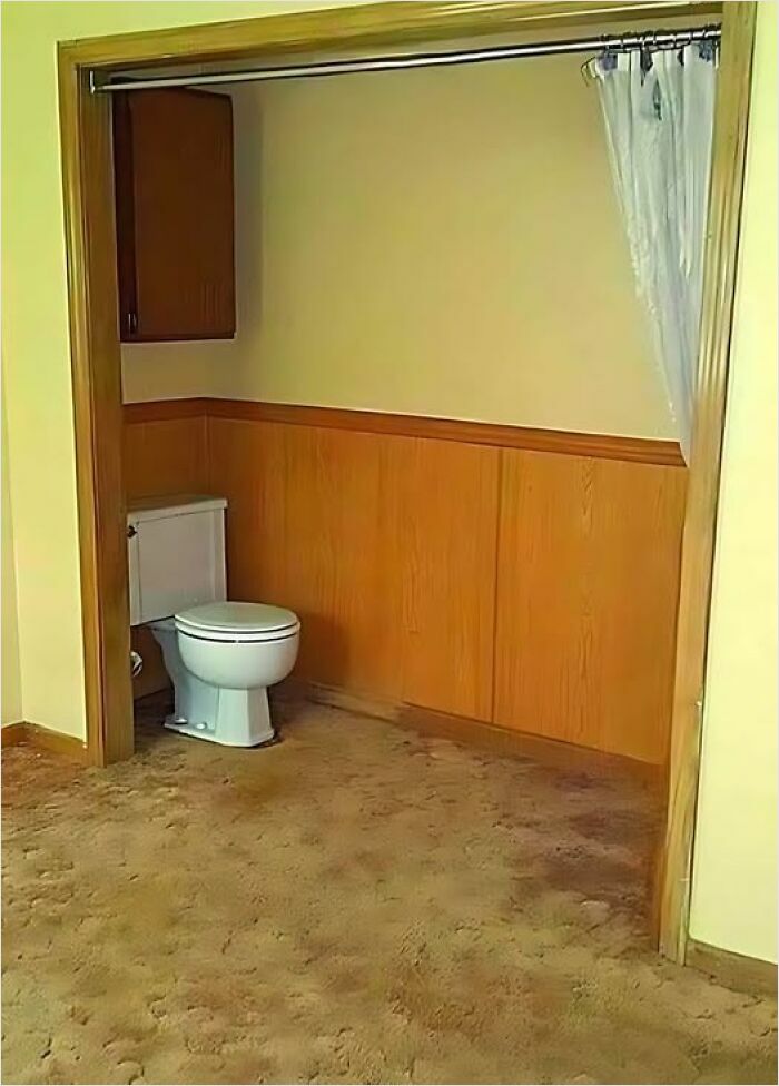 Construction fail showing a toilet awkwardly installed in a carpeted room.