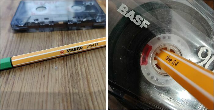 Pen perfectly fitting inside a cassette reel, demonstrating satisfying-perfect-fit concept on a wooden surface.