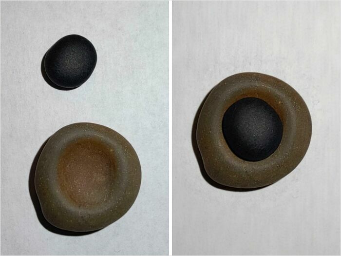 Two stones showing a satisfying perfect fit: a black pebble inside a hollow brown stone.