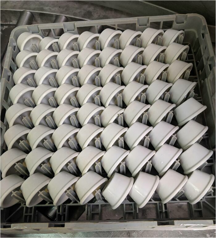 Cups stacked in a dishwasher tray, demonstrating a satisfying perfect fit with precise alignment.