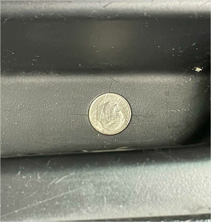 Coin perfectly fitting into a recessed groove, illustrating a satisfying perfect fit.