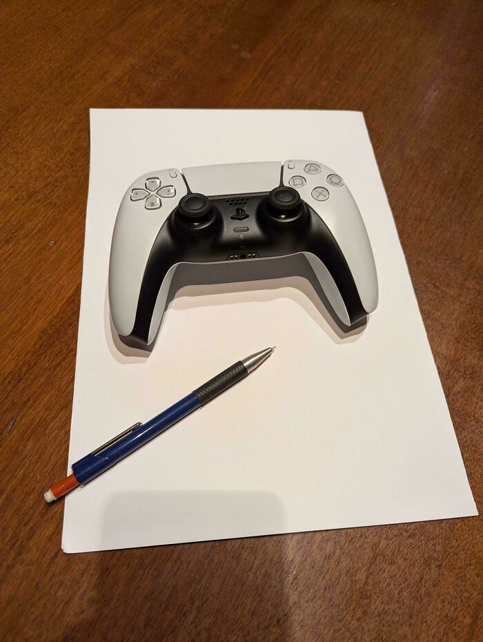 I Put A Ps5 Controller And A Pen On A Blank Sheet