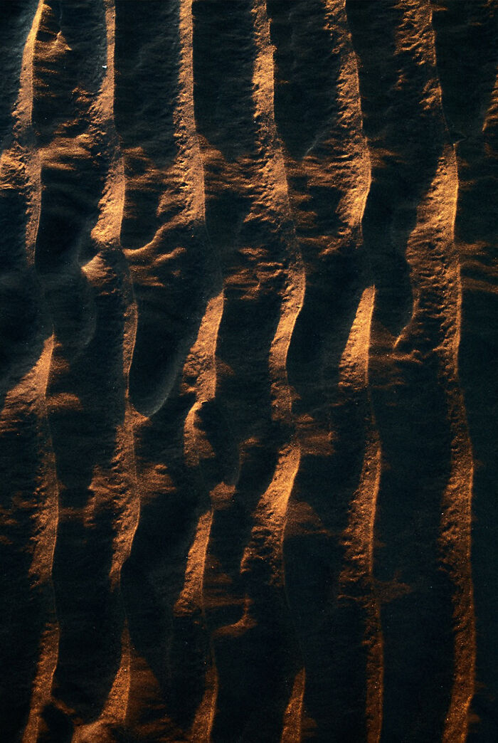 Stunning capture of waves with golden light creating mesmerizing patterns on the water surface.