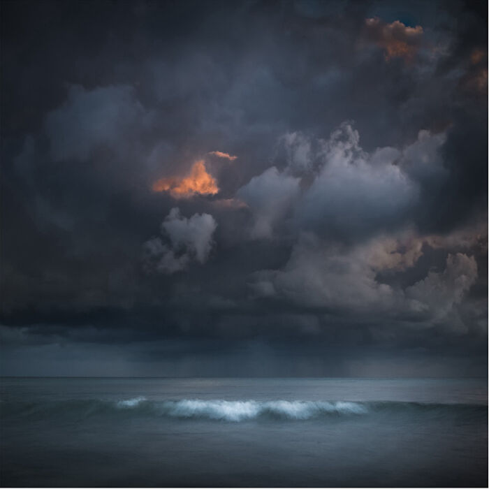 Stormy sky over ocean waves captured by a photographer.