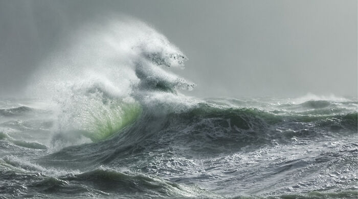 A photographer captures breathtaking, powerful ocean waves crashing dramatically.