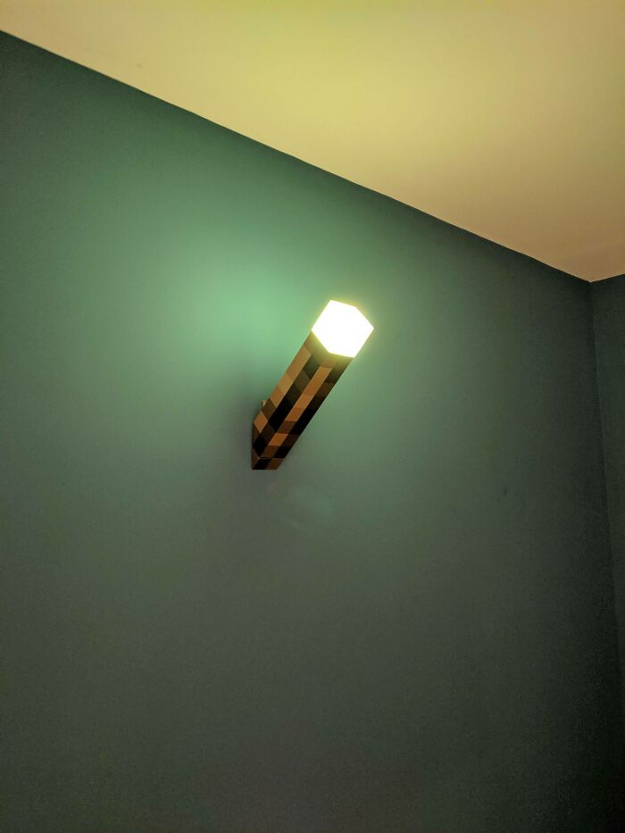 Blocky wall light fixture resembling a pixelated torch, illustrating how real-life items can look like videogames.