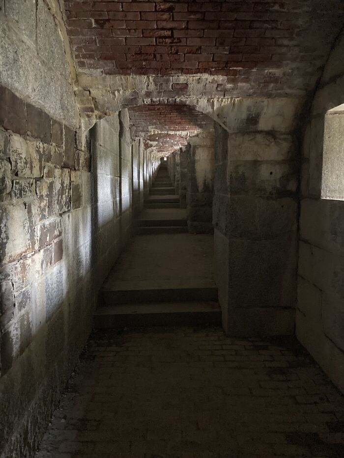 Dimly lit stone tunnel resembling a scene from a videogame.