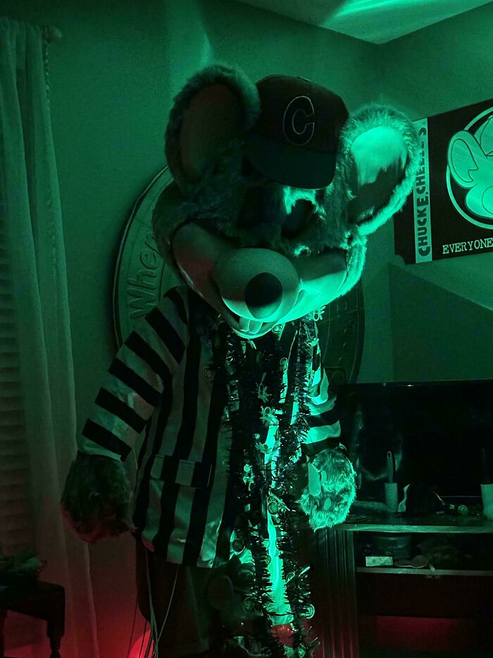 A giant mouse character with glowing green and black lighting, resembling a scene from a videogame.