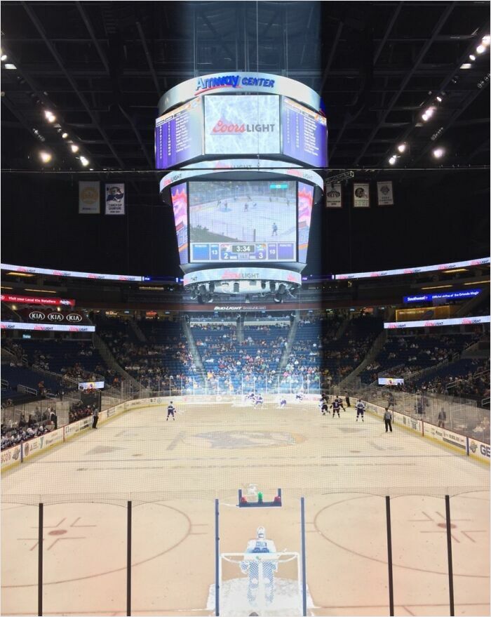 Hockey game scene in an arena that resembles graphics from a videogame.