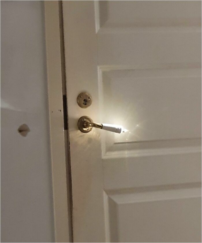 Door handle emitting light resembling a videogame graphic effect.