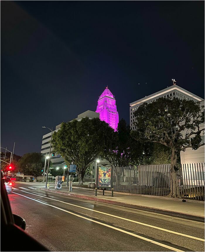 City building with pink lights at night, resembling a real-life videogame scene.