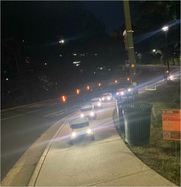 Miniature cars on a curved path at night resemble video game graphics.