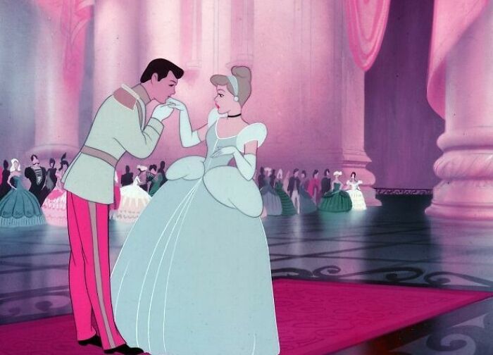 A prince and princess dancing in a grand ballroom, illustrating fascinating fan theories with elegant attire and romantic ambiance.