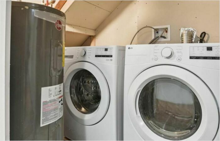 Design disaster with a cramped laundry setup featuring a water heater squeezed next to a washing machine and dryer.