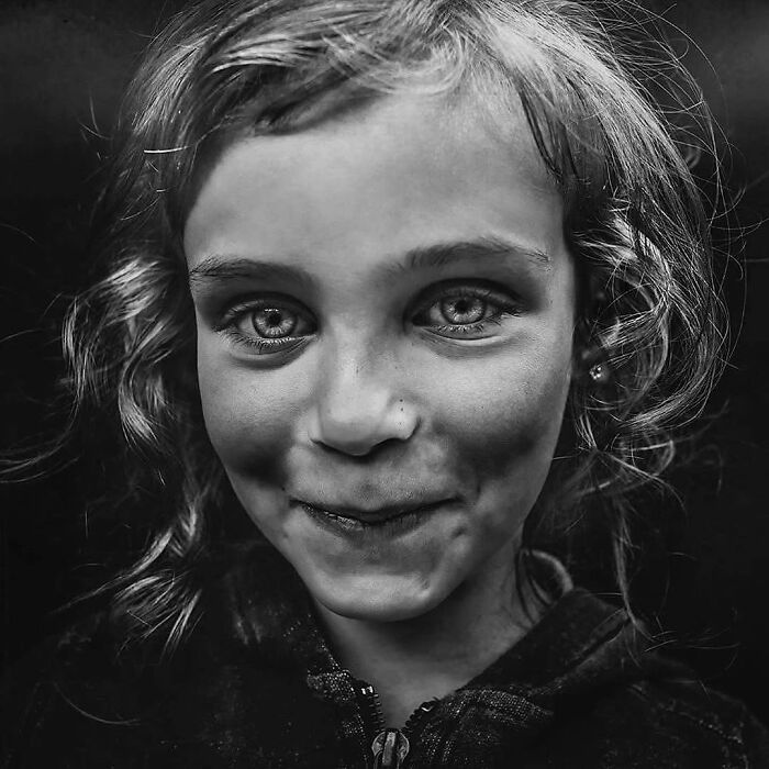 Child portrait in black and white, taken by Lee Jeffries, showcasing soulful expression and captivating eyes.