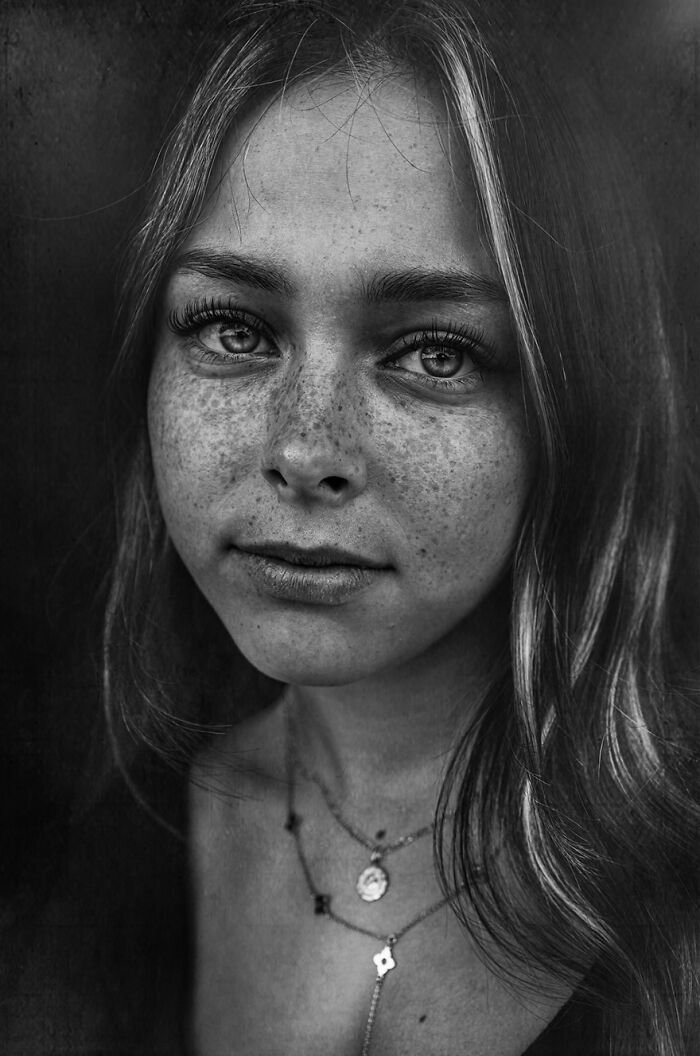 Soulful portrait of a young woman with freckles, captured by Lee Jeffries.