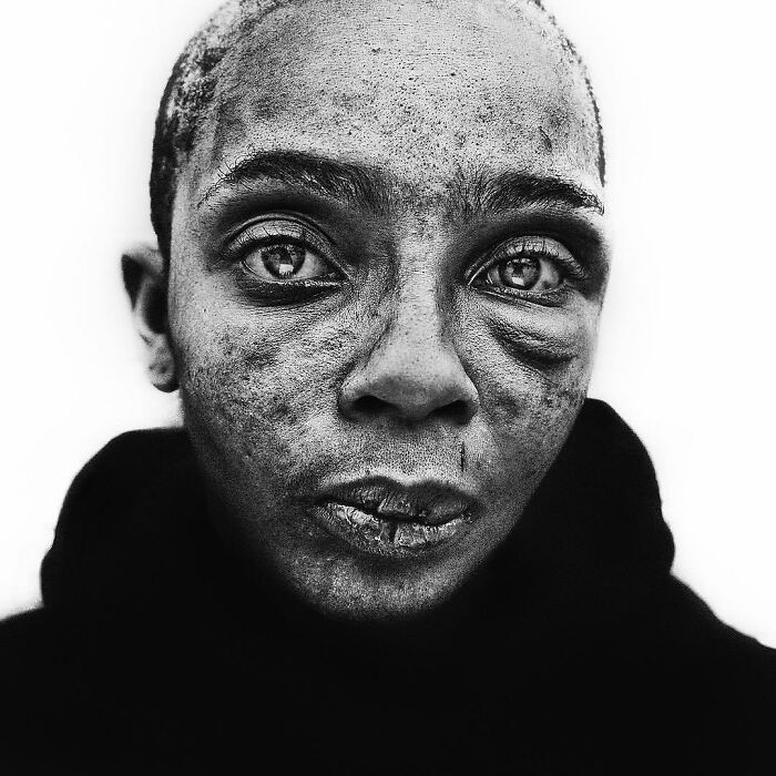 Soulful portrait of a person captured by Lee Jeffries, highlighting deep emotion and texture in their expression.