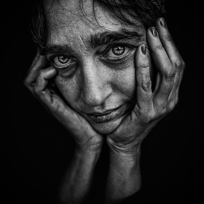 Soulful black and white portrait by Lee Jeffries, depicting deep emotion and introspection.