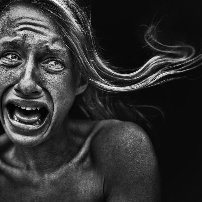 A soulful portrait of a woman expressing intense emotion, captured by photographer Lee Jeffries.