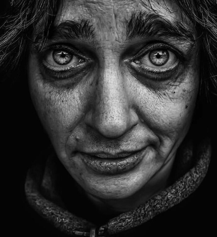 A soulful black and white portrait by Lee Jeffries, capturing profound emotion in the subject's eyes.