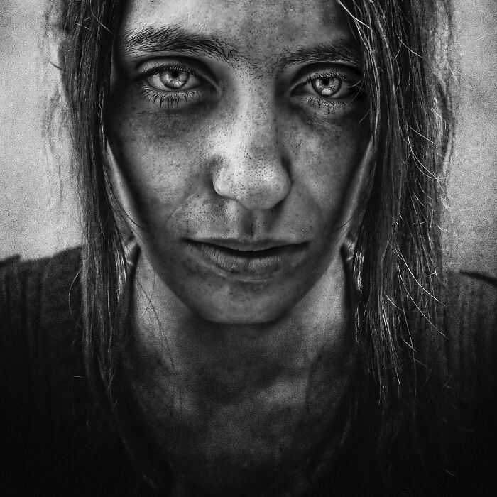 Soulful portrait by Lee Jeffries featuring a young woman with intense eyes, captured in black and white.